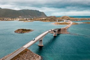 Nur the van driving along a bridge in Lofoten Islands